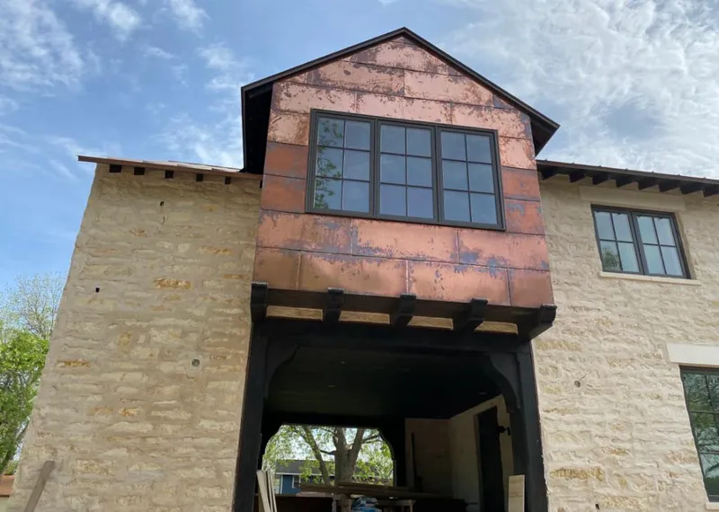 Copper metal panel facade on a stone building for Skylight Installation in Guntersville