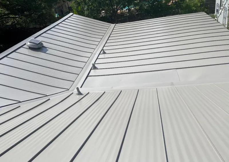 Solar attic fan installed on a metal roof for Roof Ventilation in Guntersville